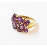 A 9ct. gold dress ring, set with amethysts and tiny diamonds