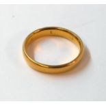 A 5.5grms high carat wedding band - marks worn