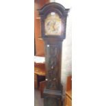 An early 20th Century oak cased grandmother clock with decorative spandrels to arch dial with