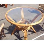 A glass topped cane framed conservatory table