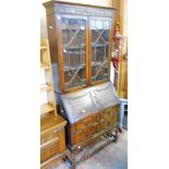 A 3' 2" early 20th Century oak bureau/bookcase with blind fretwork and astrajal glazed top over a