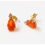 A pair of marked 375 yellow metal ear-rings, each set with drop shaped fire opal and small diamond