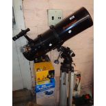 A Celestron large telescope with tripod, books and accessories
