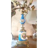 A decorative gilt brass four branch candleabrum with hand painted ceramic mounts