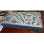 A 21 1/2" vintage locker footstool with floral tapestry to top, set on turned feet