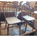 A set of four old hoop stick back kitchen chairs with moulded solid elm seats, bearing matching