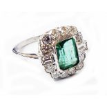 A marked PLAT Art Deco style ring, set with central oblong emerald within a diamond border with