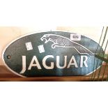 A modern reproduction painted iron Jaguar sign