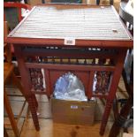 A 19" Indo-Persian red painted wood table with woven rush inset top and intricate spindle panels,