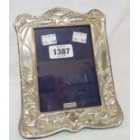 A modern silver fronted photograph frame in the Art Nouveau style with wooden easel back - to take