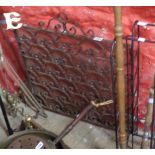 A wrought iron and mesh fire screen with fleur de lys design - sold with a copper warming pan, two