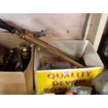 A box containing three vintage brass garden sprayers and two brass blow torches