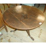 A 29" diameter antique oak pedestal table, set on shortened pillar and tripod base with pad feet