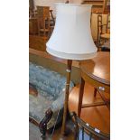 A 20th Century stained wood standard lamp and shade with reeded pillar and circular foot - for re-