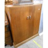 A 93cm 1930's oak linen press with five slides enclosed by a pair of cupboard doors, set on reeded