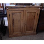 A 96cm Victorian stripped pine two door cupboard, set on plinth base - one backboard, handles and