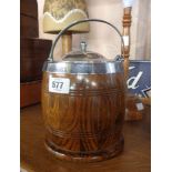 An oak biscuit barrel with silver plated lid and handle and ceramic liner