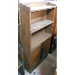 A 55cm oak open bookcase with double cupboard under