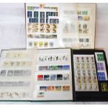 Three stock books containing a collection of mint mainly decimal GB stamps, including part sheets