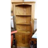 A 96cm 20th Century waxed pine corner unit with three open shelves, canted corners and pair of