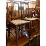 A pair of Edwardian mahogany strung stick back bedroom chairs with rattan seat panels - sold with