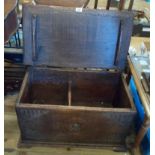 A 71cm 20th Century heavy oak lift top linen chest in the antique style with carved galleon