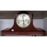 A 1920's stained mixed wood cased Napoleon hat mantle clock with German eight day chiming movement