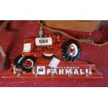 A reproduction painted cast metal tractor key hook