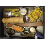 A box containing various items including a 1793 Manchester half penny token, tyre pressure gauge,