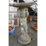 A cast concrete birdbath set on a putto pedestal base - dish top a/f