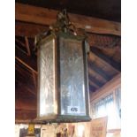 A brass faceted hall lantern with bevelled and star cut panes