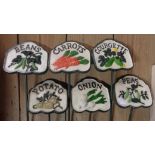 A set of six painted cast metal vegetable labels