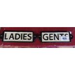 A pair of painted cast metal signs, "Ladies" and "Gents"