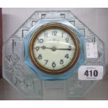 A 1930's pale blue moulded blue glass framed bedside table timepiece with simple thirty hour