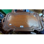 A 61.5cm Anglo Indian hardwood tea tray with decorative, incised and carved borders with flanking