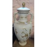 A painted pottery urn embossed in the classical style and over painted, with lid