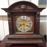 A late 19th Century German oak cased table clock with brass and silvered dial, P.H. & S. eight day