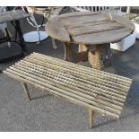 A 1m diameter teak garden table set on quadruple shaped supports - sold with a slatted garden