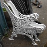 A pair of reproduction painted cast iron bench ends with decorative pierced decoration