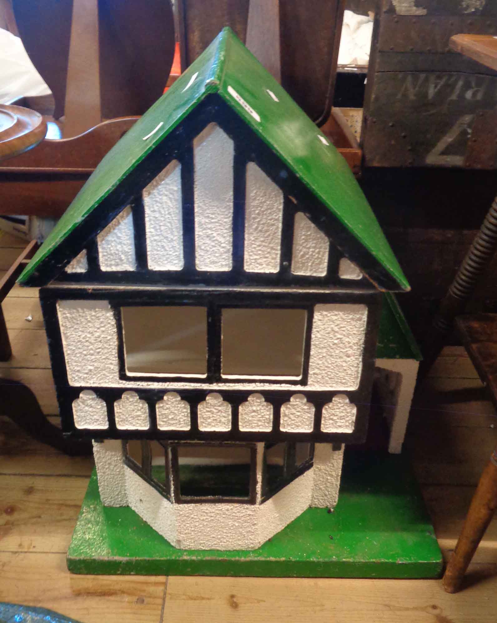 A vintage dolls house with gabled front in the Mock Tudor style