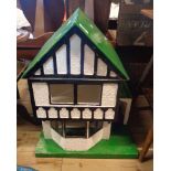 A vintage dolls house with gabled front in the Mock Tudor style