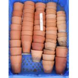 A crate containing a selection of terracotta seedling pots