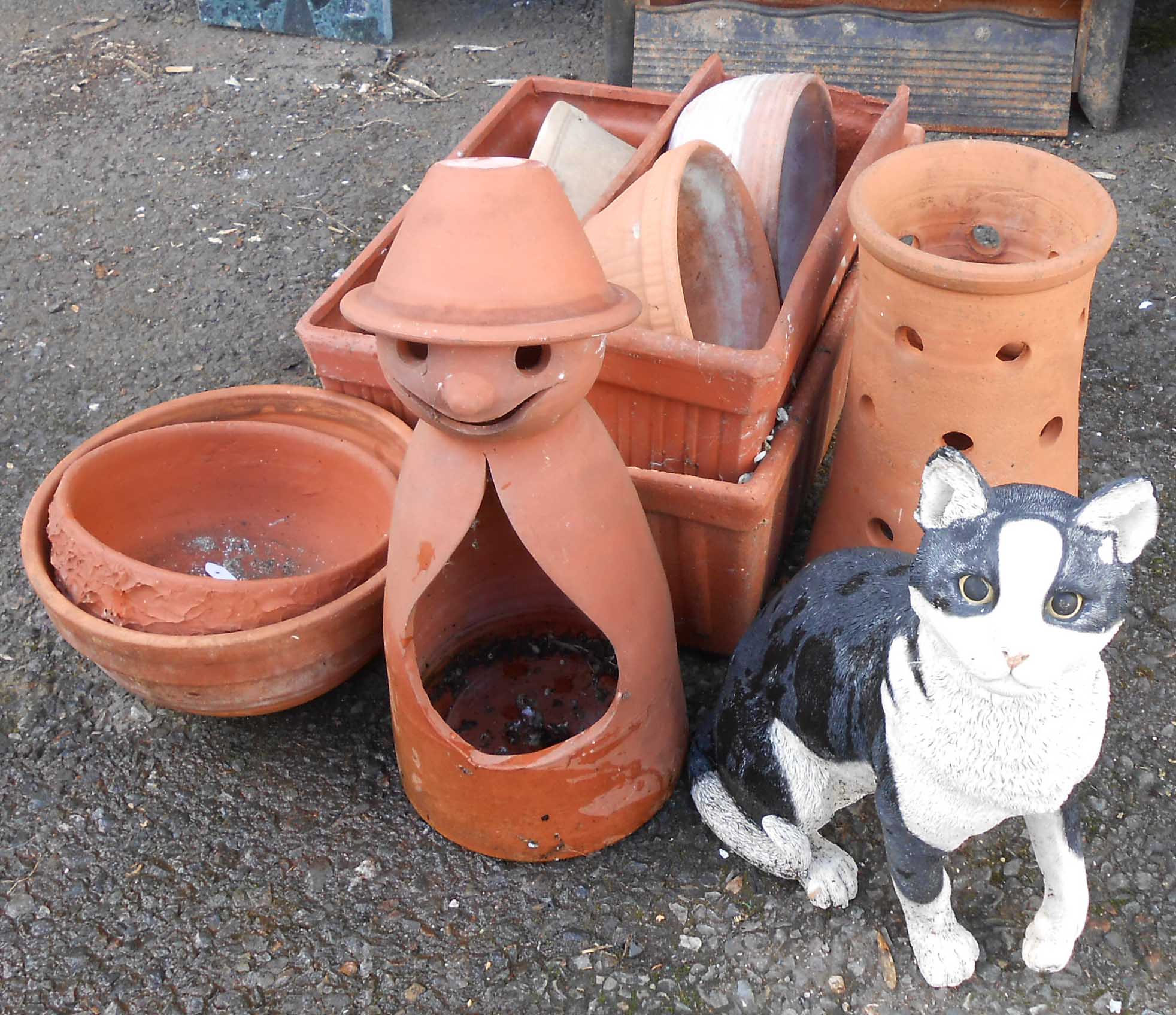 A selection of modern terracotta bowls, oblong planters, conical planter, figural planter and