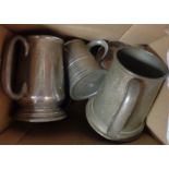 A box containing a quantity of pewter mugs