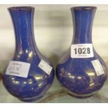 A pair of 1930's Moorcroft powder blue vases with purple lustre glaze