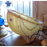 A yellow mottled glass lampshade with tassels