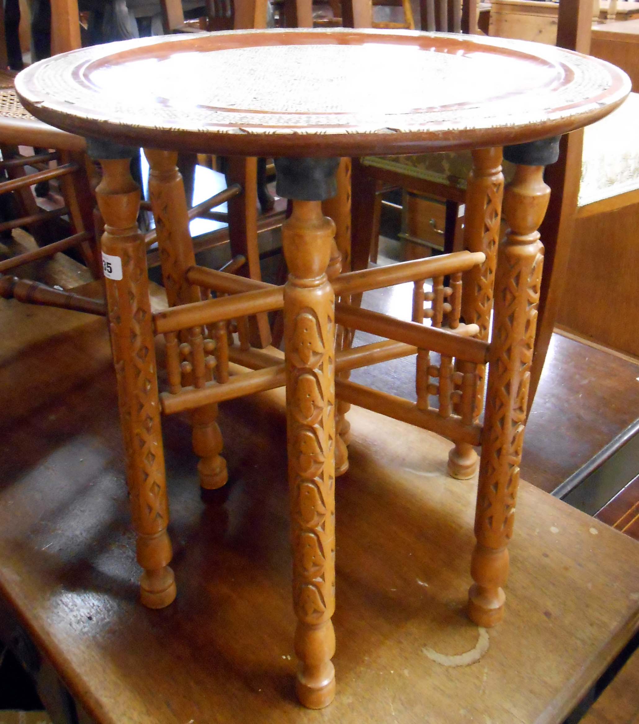 A 50.5cm diameter 20th Century Islamic Khatam inlaid topped table, set on decorative folding