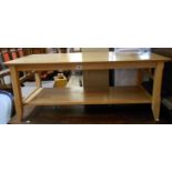 A 1.11m modern golden oak coffee table with undertier and shaped supports