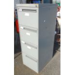 A grey painted metal four drawer filing cabinet