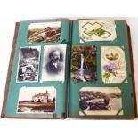 An early 20th Century postcard album containing a collection of corner mounted cards, including